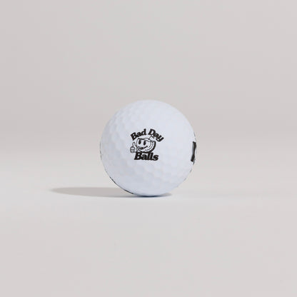 The Mulligan golf ball resting on a tee against a white background, showing main logo