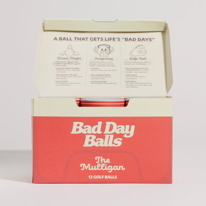 An open cooler for golf balls, with 'Bad Day Balls The Mulligan 12 Golf Balls' 